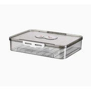 Clear plastic egg storage container with a white latch and two circular labels on the lid.
