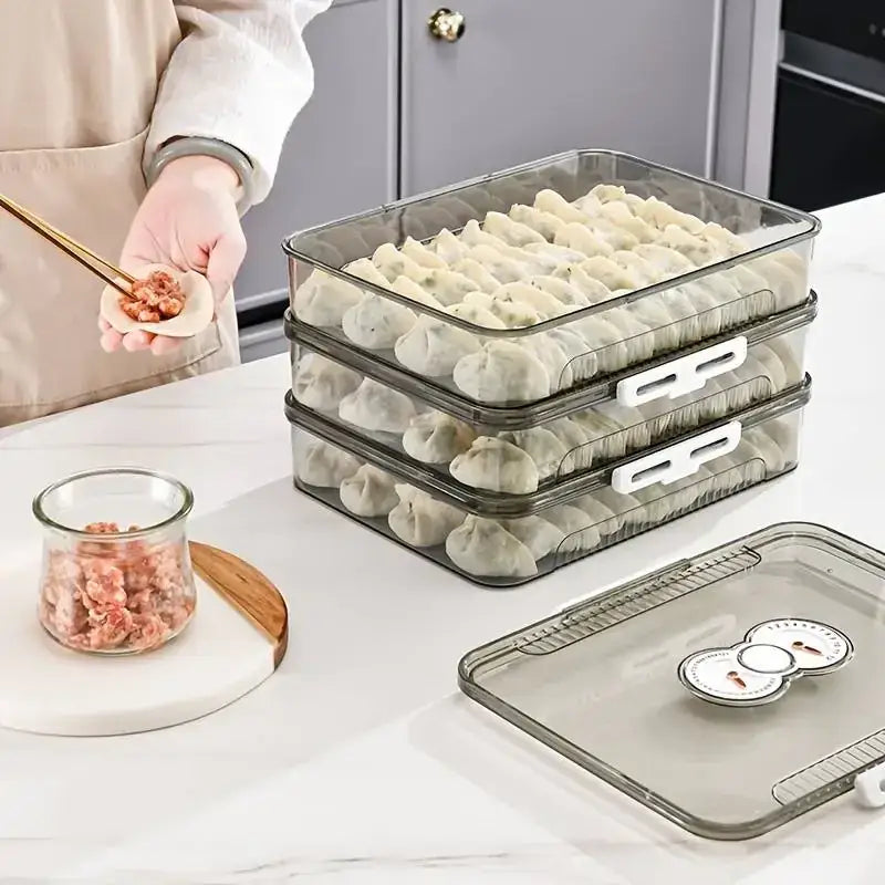 Transparent plastic stackable dumpling storage containers with white latches and a matching lid featuring circular temperature indicators.