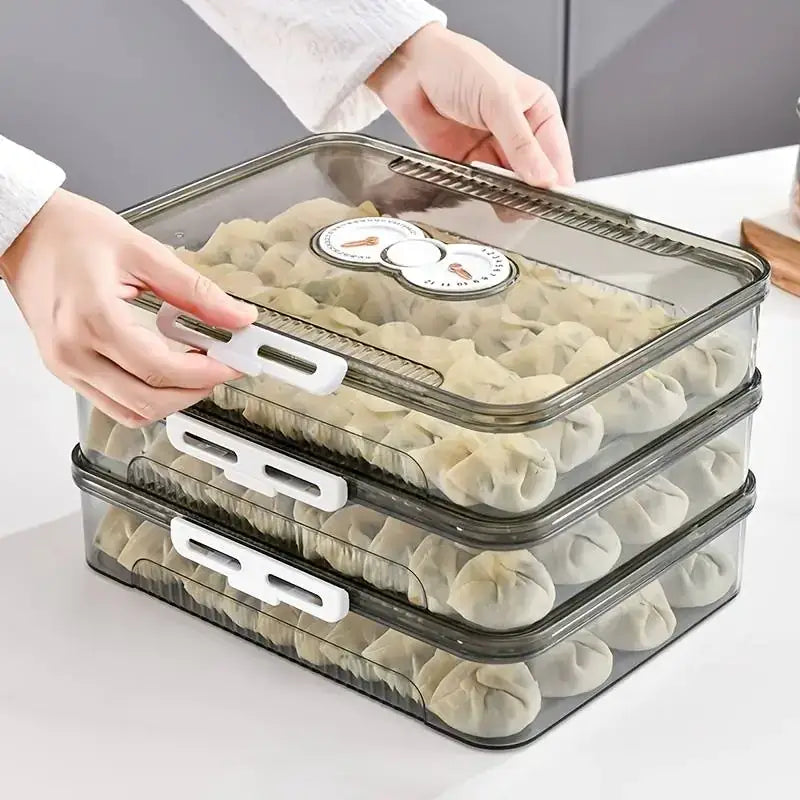 Transparent plastic stackable dumpling storage containers with white latches and a circular temperature indicator on the lid.