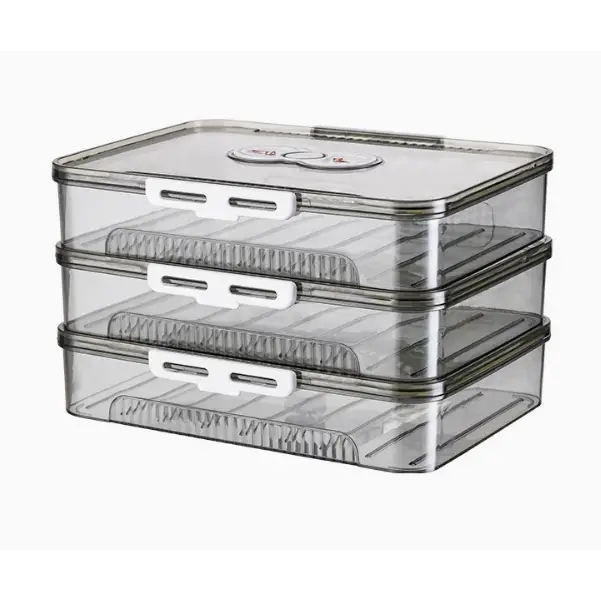 Transparent plastic stackable food storage containers with white latches and ridged interior dividers.
