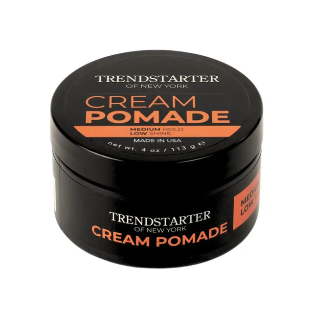 Black cylindrical jar of trendstarter of new york cream pomade with orange and white labeling.