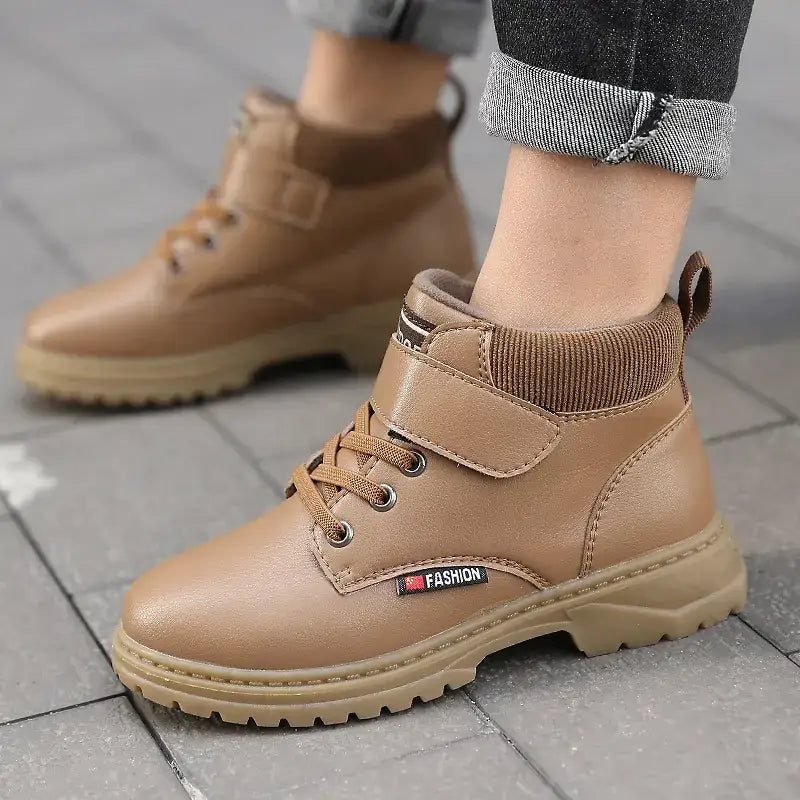 Tan faux leather ankle boots with a ribbed knit collar and velcro strap, featuring a chunky rubber sole.