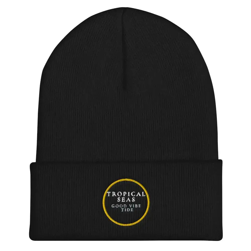 Black knit beanie with a folded cuff and embroidered gold circular logo reading ’tropical seas good vibe tide’.