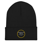 Black knit beanie with a folded cuff and embroidered gold circular logo reading ’tropical seas good vibe tide’.