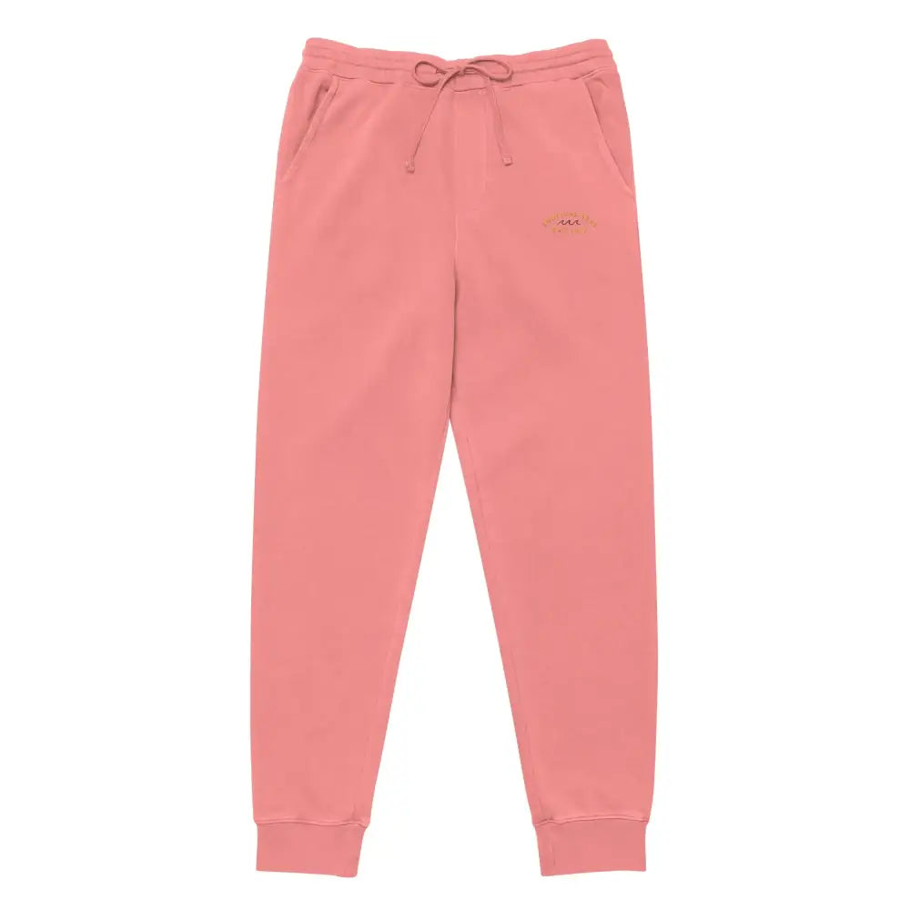 Coral pink jogger pants with a drawstring waistband and subtle embroidered logo on the thigh.