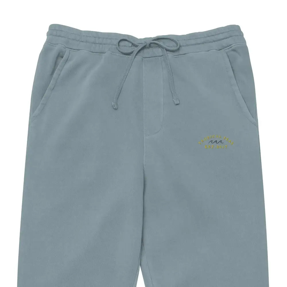 Light blue sweatpants with a drawstring waistband and subtle embroidered logo on the thigh.