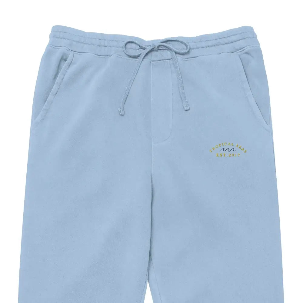 Light blue cotton sweatpants with a drawstring waistband and embroidered logo on the left thigh.