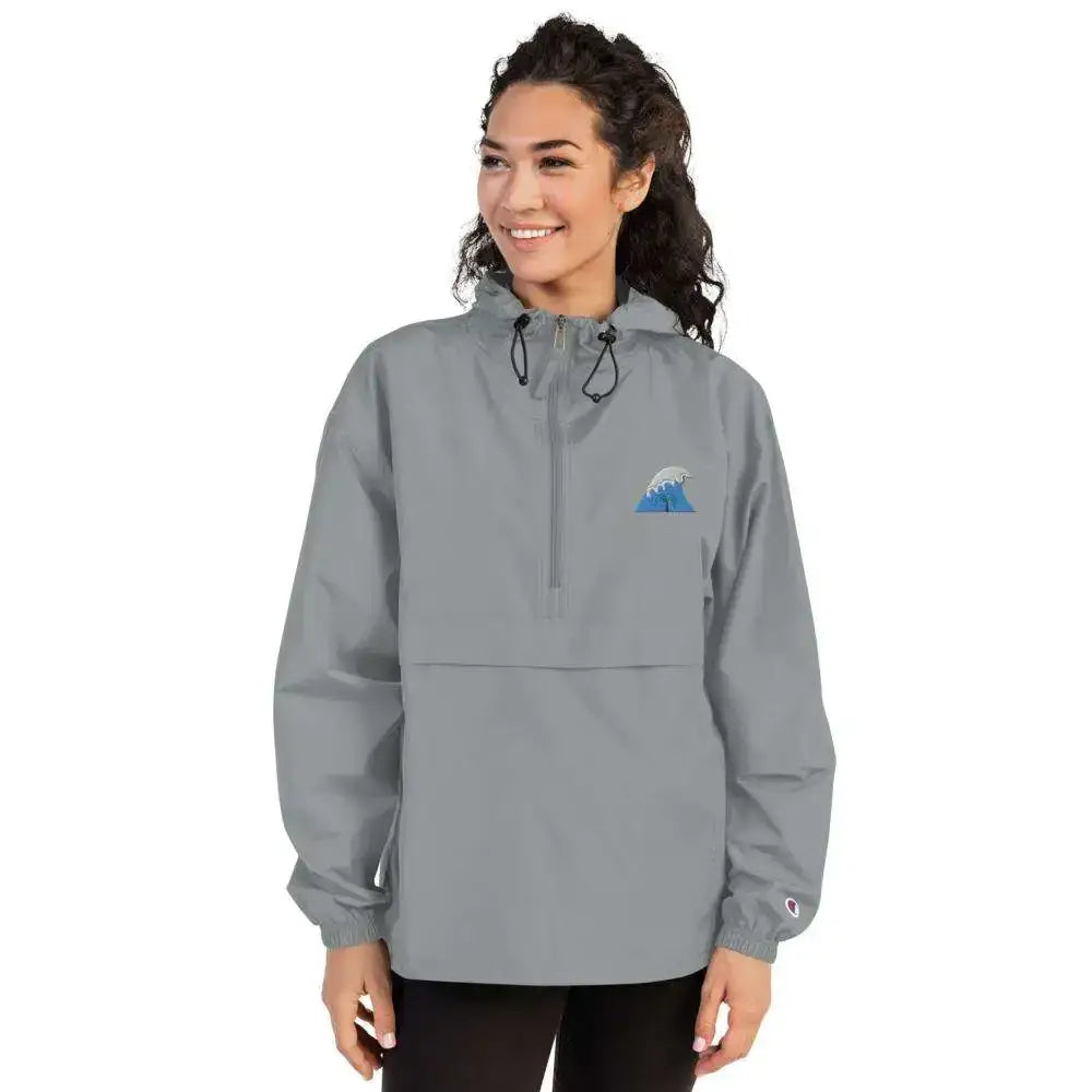 Gray champion half-zip anorak jacket with a blue wave logo on the chest and a small embroidered brand patch on the sleeve.