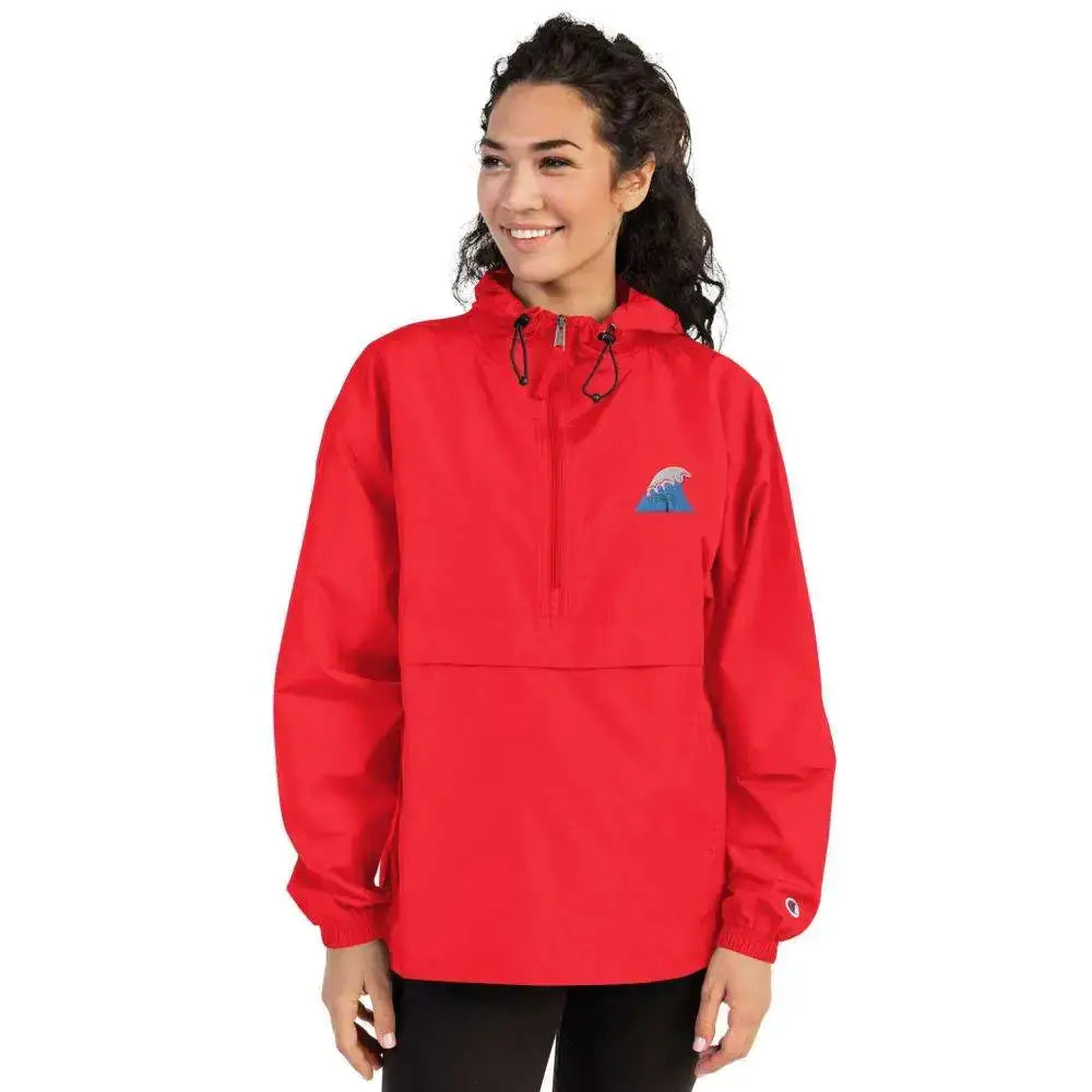 Red champion half-zip hooded jacket with a blue wave logo on the chest and a small embroidered brand patch on the sleeve.