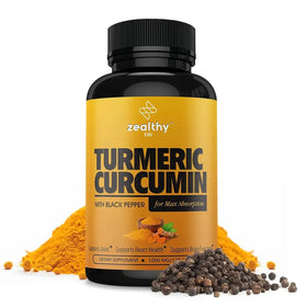 A black bottle with a vibrant yellow label featuring the brand ’zealthy life’ and product name ’turmeric curcumin with black pepper for max absorption,’ surrounded by piles of turmeric powder and whole black peppercorns.