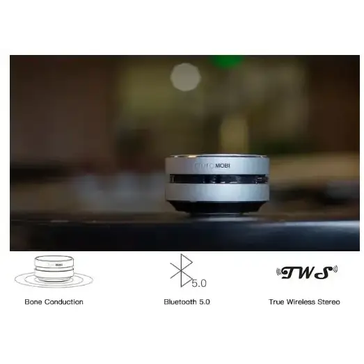 Silver cylindrical wireless earbud case with a sleek, minimalist design and black accents.