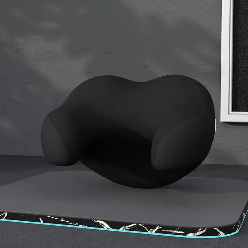 Black ergonomic neck pillow with contoured shape and soft fabric surface