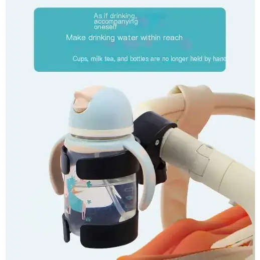 Light blue and black sippy cup with a cartoon unicorn design, attached to a stroller handle via a black clip.