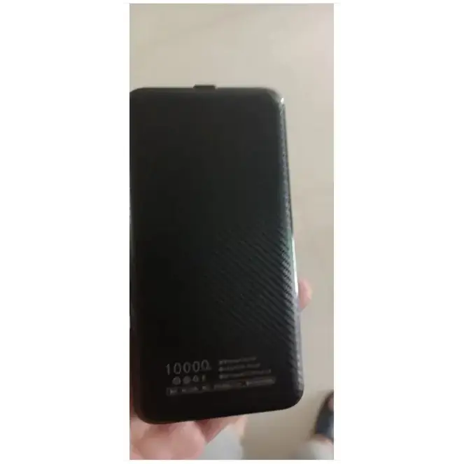 Black rectangular power bank with a textured carbon fiber pattern and ’10000’’ printed in white at the bottom.