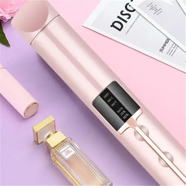 Pink metallic hair curler with a digital display showing temperature and humidity settings.