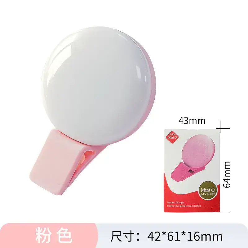 Pink mini q selfie clip-on light with a round, glossy white illuminated face and a soft silicone grip.