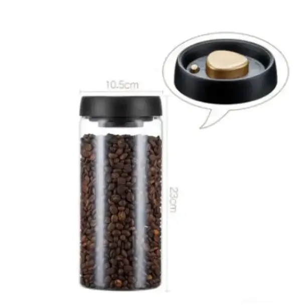 Transparent cylindrical coffee bean storage jar with a black lid and gold-toned inner mechanism.