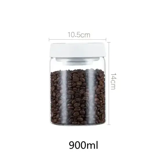 Clear glass jar with a white lid, filled with dark brown coffee beans.
