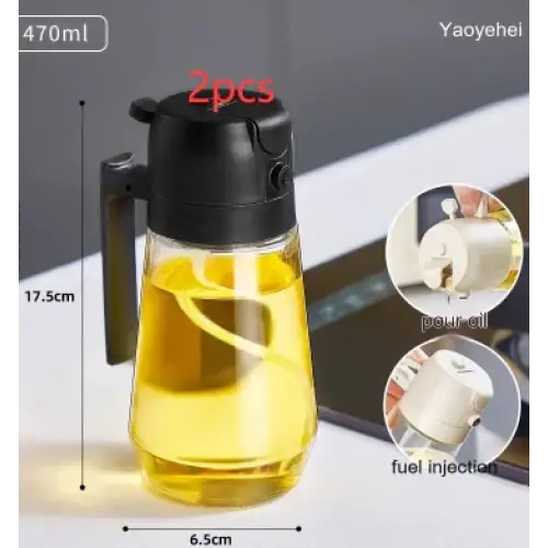 Clear glass oil dispenser with black handle and pump top, filled with golden-yellow liquid.