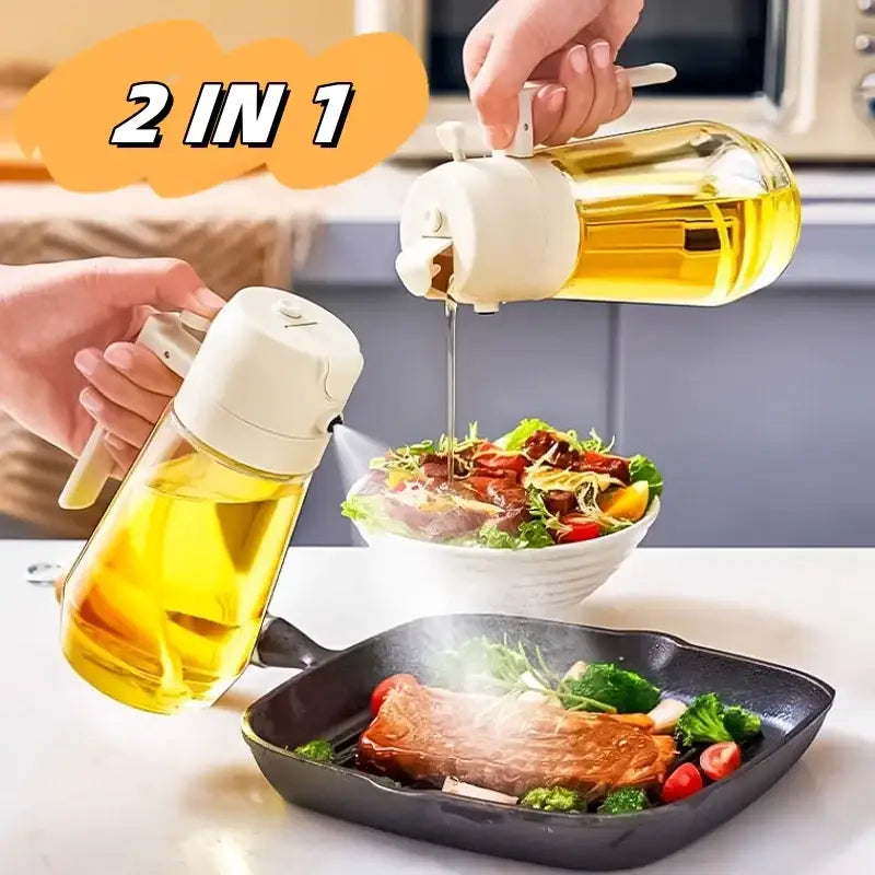 Clear glass oil dispenser with white plastic top and handle, designed for both pouring and spraying.