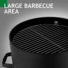 Black cylindrical barbecue grill with a shiny stainless steel grilling rack.