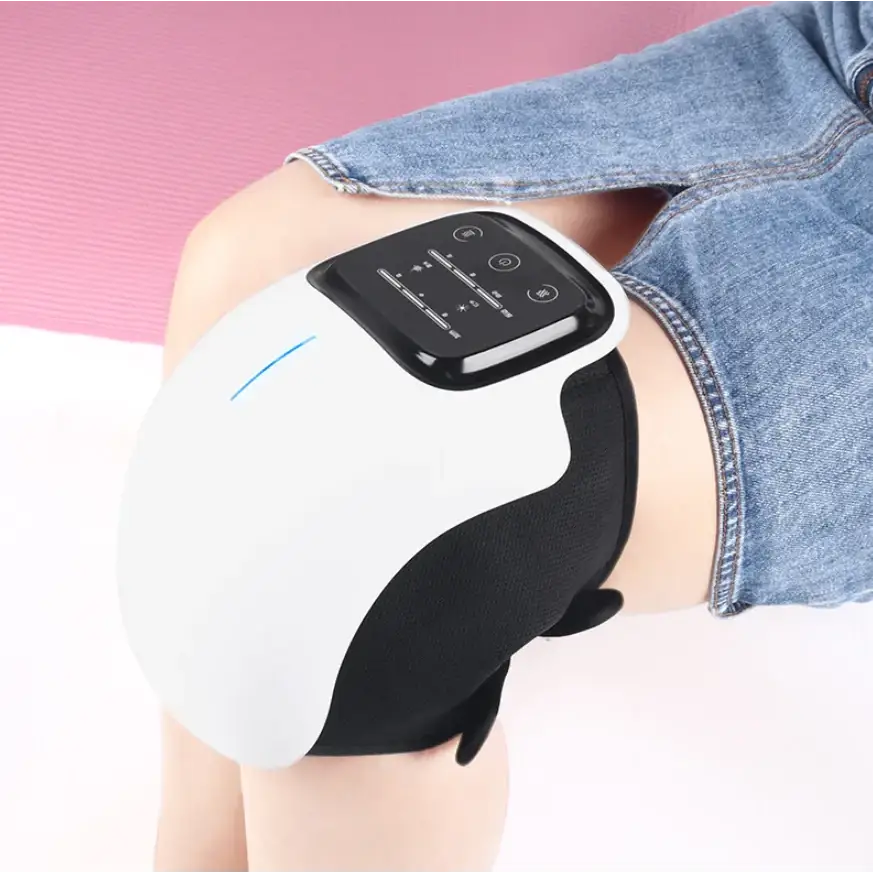 White and black electronic knee massager with a sleek, ergonomic design featuring a control panel on the top.