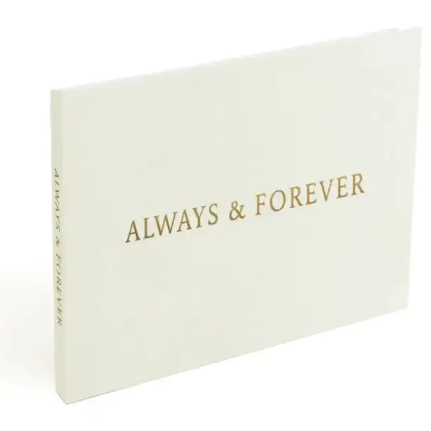 Cream-colored hardcover photo album with gold foil lettering that reads ’always & forever’ on the front and spine.