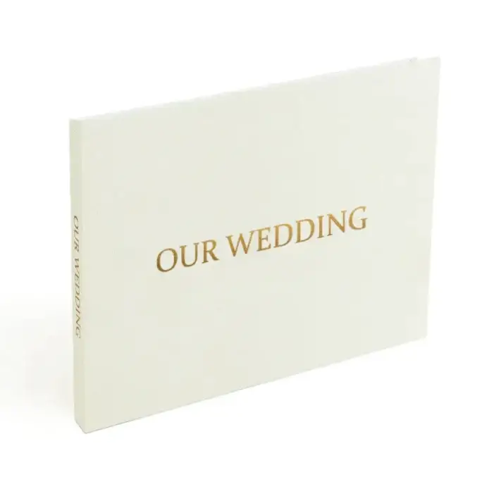 Cream-colored wedding photo album with elegant gold foil lettering.