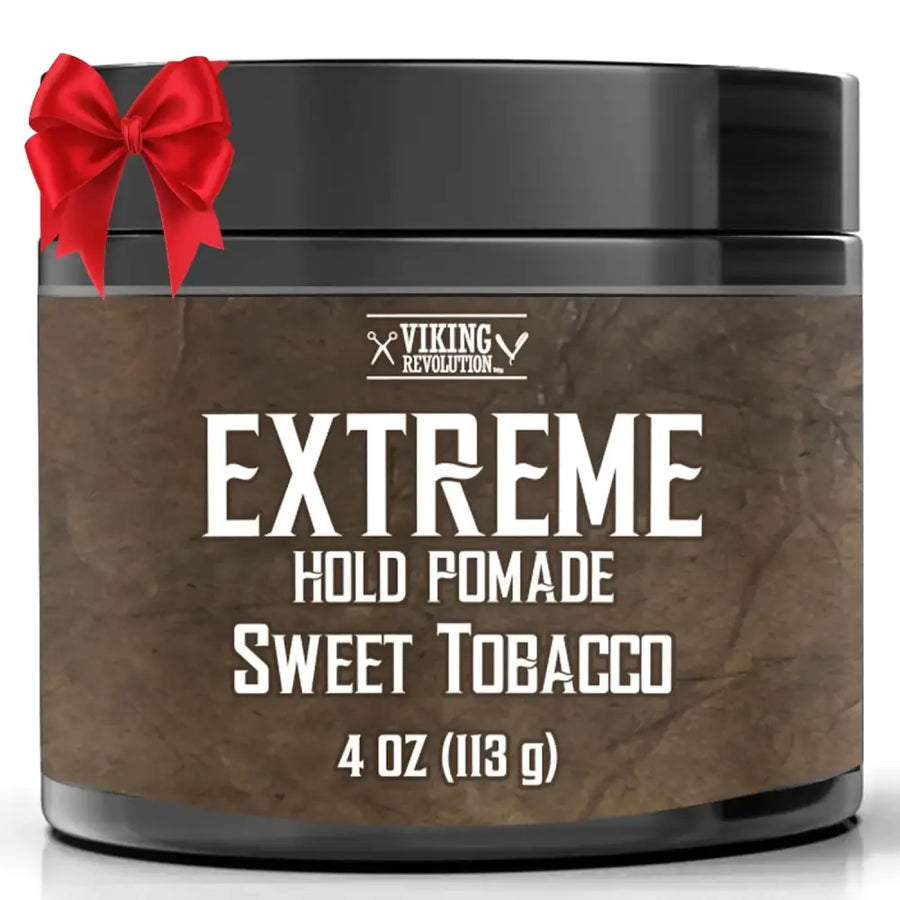 Black cylindrical container of viking revolution extreme hold pomade in sweet tobacco scent, featuring a textured brown label with white lettering and a red satin bow tied around the lid.