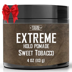 Black cylindrical container of viking revolution extreme hold pomade in sweet tobacco scent, featuring a textured brown label with white lettering and a red satin bow tied around the lid.
