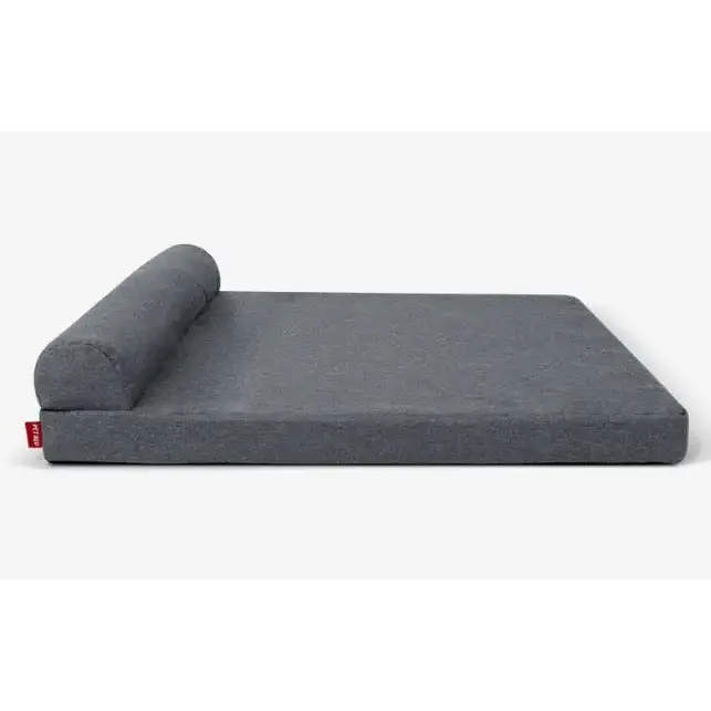 Gray fabric pet bed with a rolled-up cushion at one end.