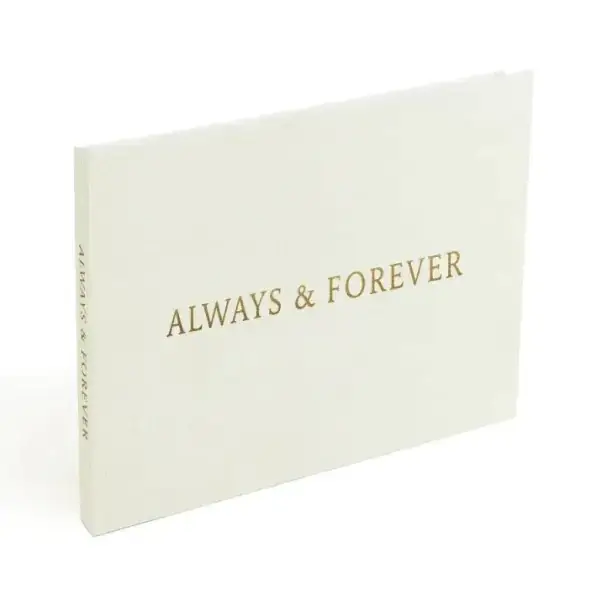 Cream-colored hardcover photo book with gold foil lettering that reads ’always & forever’ on the front cover.