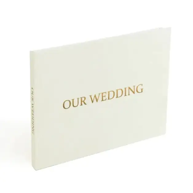 Cream-colored wedding album with gold foil lettering.