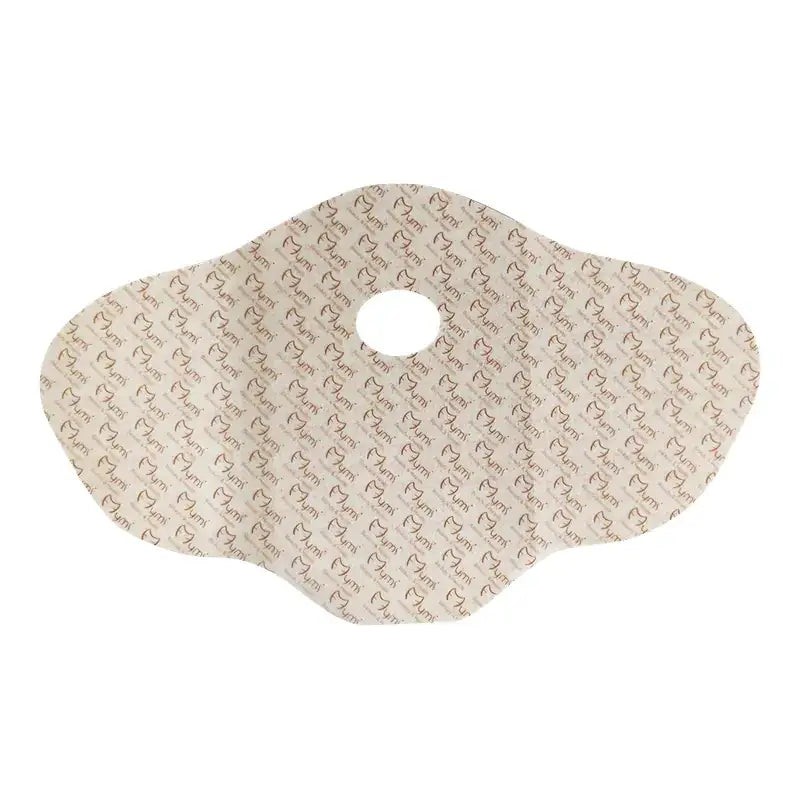 Beige-colored, heart-patterned umi brand incontinence pad with a central hole.