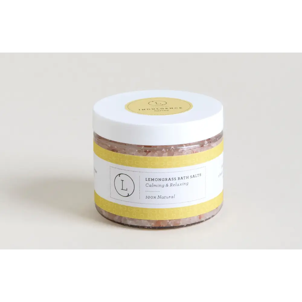 White jar with yellow label and lid, containing pinkish lemongrass bath salts.