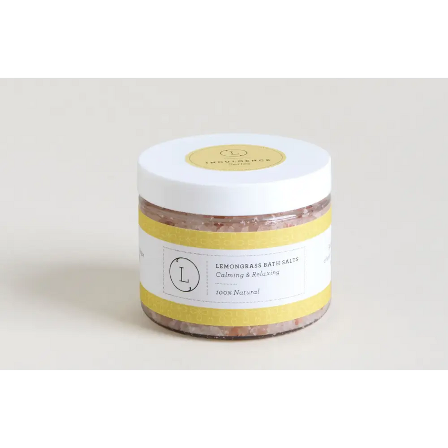 White jar with yellow label and lid, containing pinkish lemongrass bath salts.