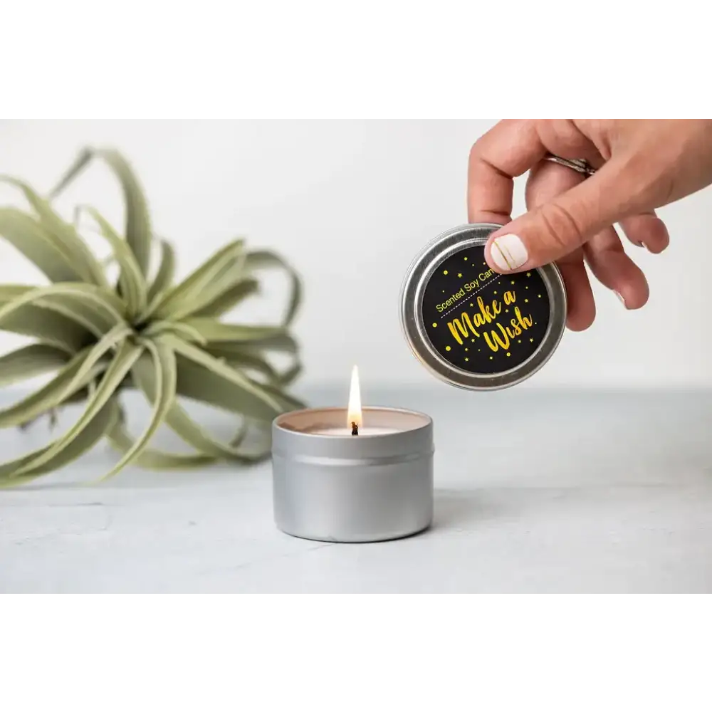 Silver tin scented soy candle with black lid featuring gold foil text that reads ’make a wish’