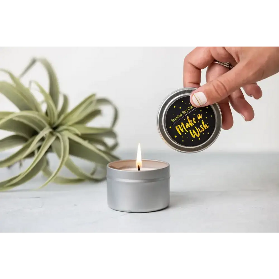 Silver tin scented soy candle with black lid featuring gold foil text that reads ’make a wish’