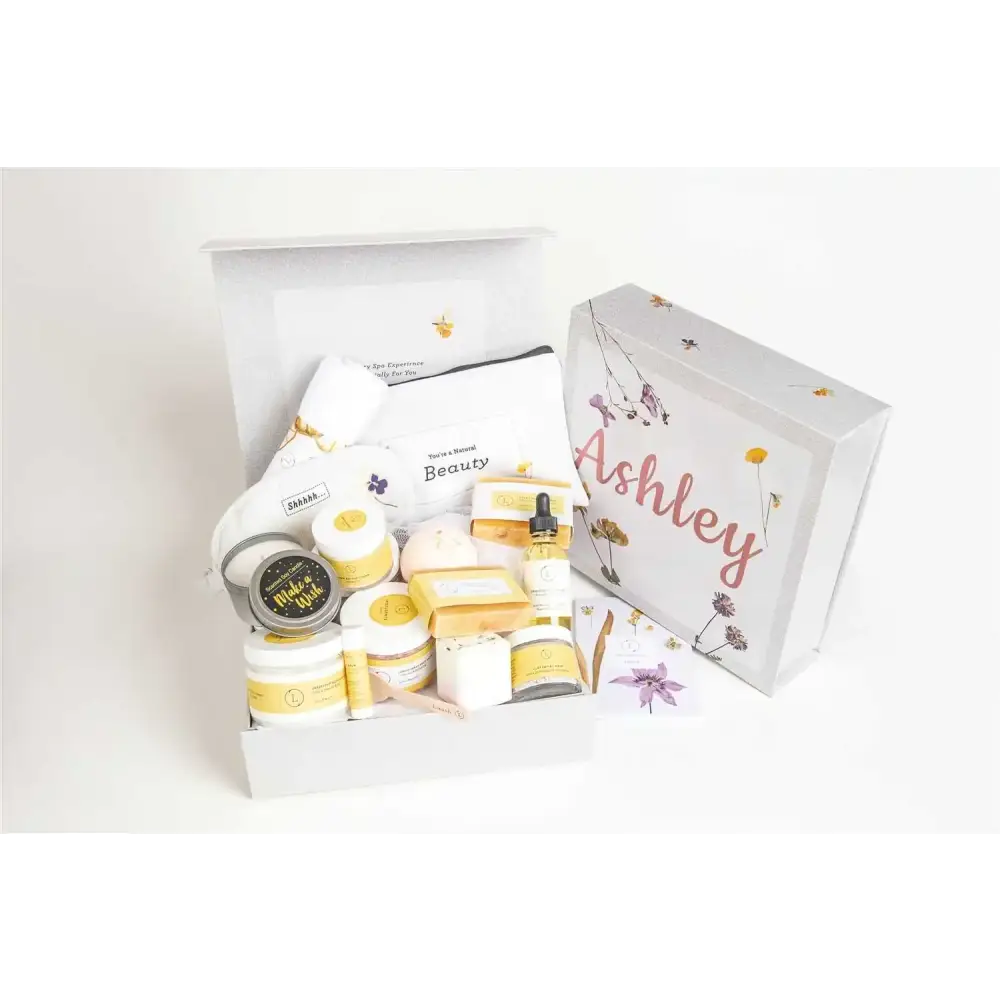 White gift box with floral and bee illustrations, personalized with the name ’ashley’ in pink cursive script.