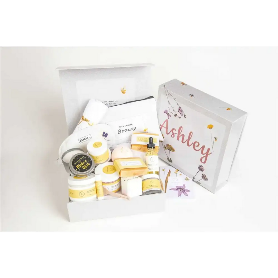 White gift box with floral and bee illustrations, personalized with the name ’ashley’ in pink cursive script.