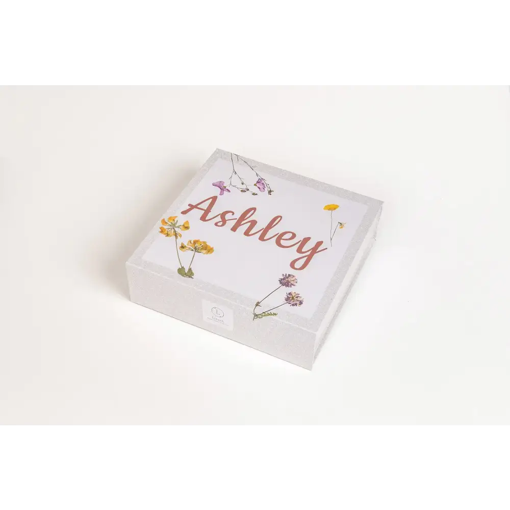 White square gift box with delicate floral illustrations and the name ’ashley’ in a warm, cursive script.