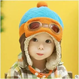 Blue and orange quilted winter hat with faux fur trim and a pom-pom on top