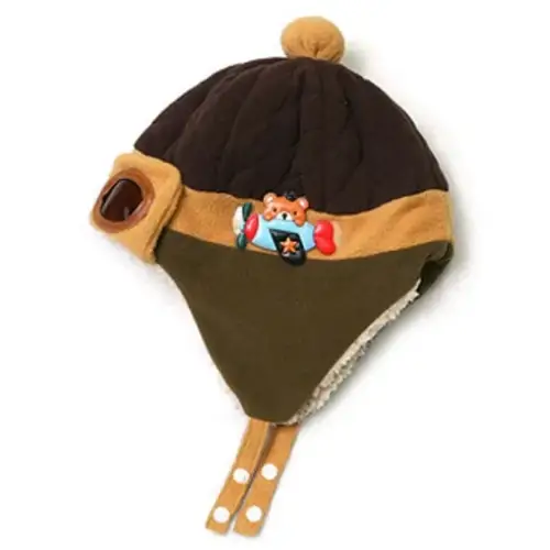 Brown and olive green quilted winter hat with tan trim, a pom-pom on top, and an embroidered airplane design.