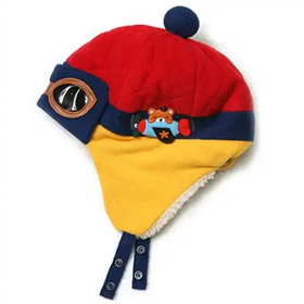 Red and yellow quilted winter hat with a navy blue pom-pom, embroidered airplane patch, and snap closures.