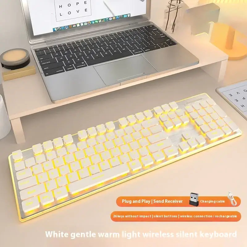 White wireless keyboard with warm yellow backlighting and a sleek, minimalist design.