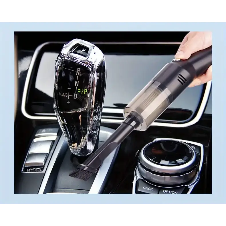 Black handheld car vacuum with transparent dust container and brush attachment