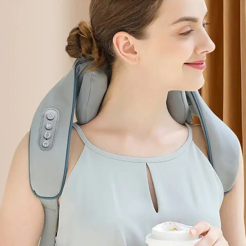 Gray fabric neck massager with control buttons on the side.
