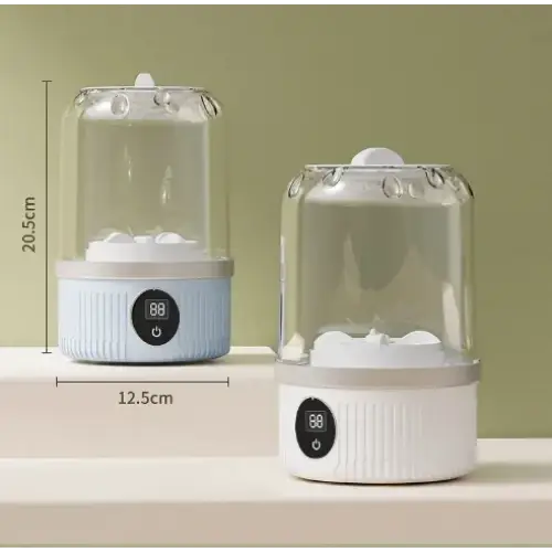 Light blue and white electric egg cooker with transparent glass dome.