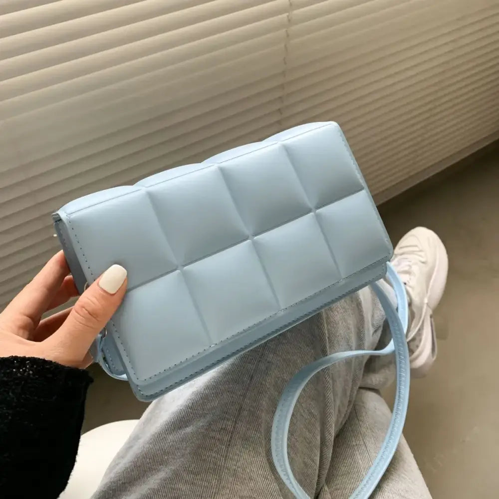 Light blue quilted crossbody bag with matching strap