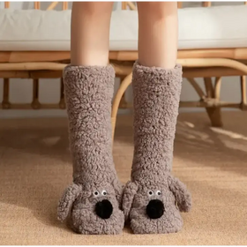 Gray plush dog-shaped slippers with black pom-pom noses and googly eyes.